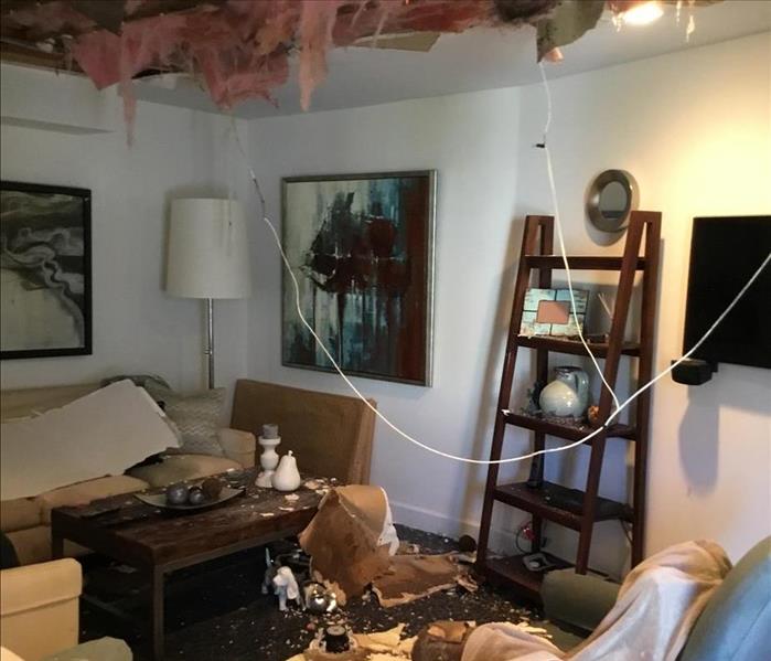 Ceiling caving into room with major flood damage. 